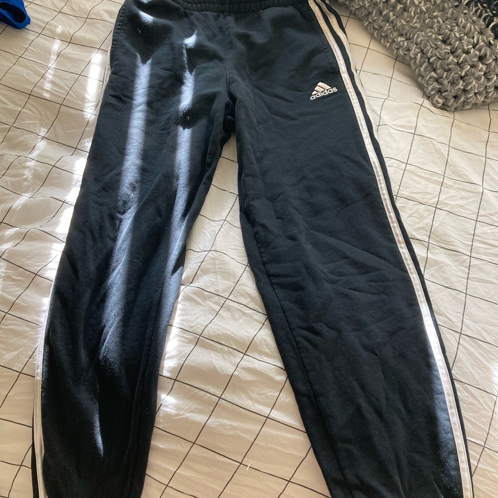Black sweatpants with white stripes down the side of legs, size Large in kids